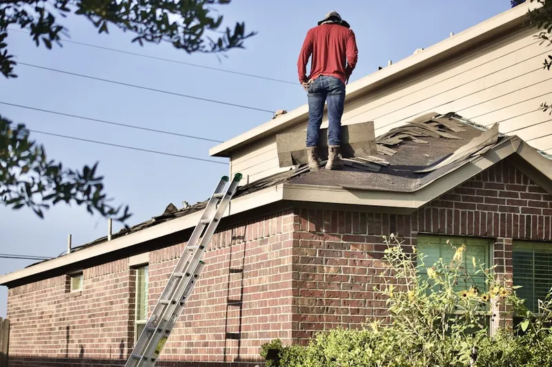 Professional roofer working on a residential roof in Reminderville